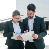 Business professionals reviewing documents Business professionals reviewing documents