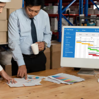 Managers reviewing warehouse data Managers reviewing warehouse data