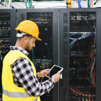 Engineer inspecting server racks Engineer inspecting server racks