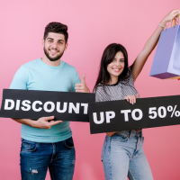 Couple with discount signs Couple with discount signs