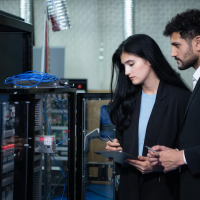 Engineers inspecting server cabinet Engineers inspecting server cabinet